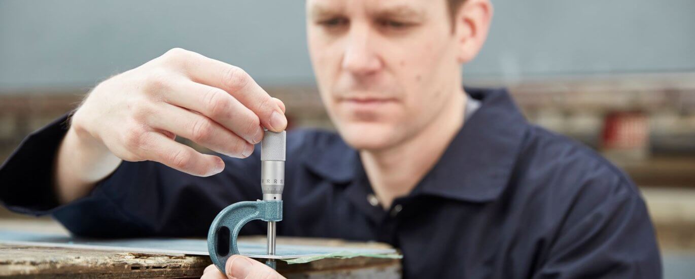 Engineer measuring using a micrometer