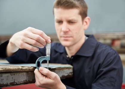 Engineer measuring using a micrometer